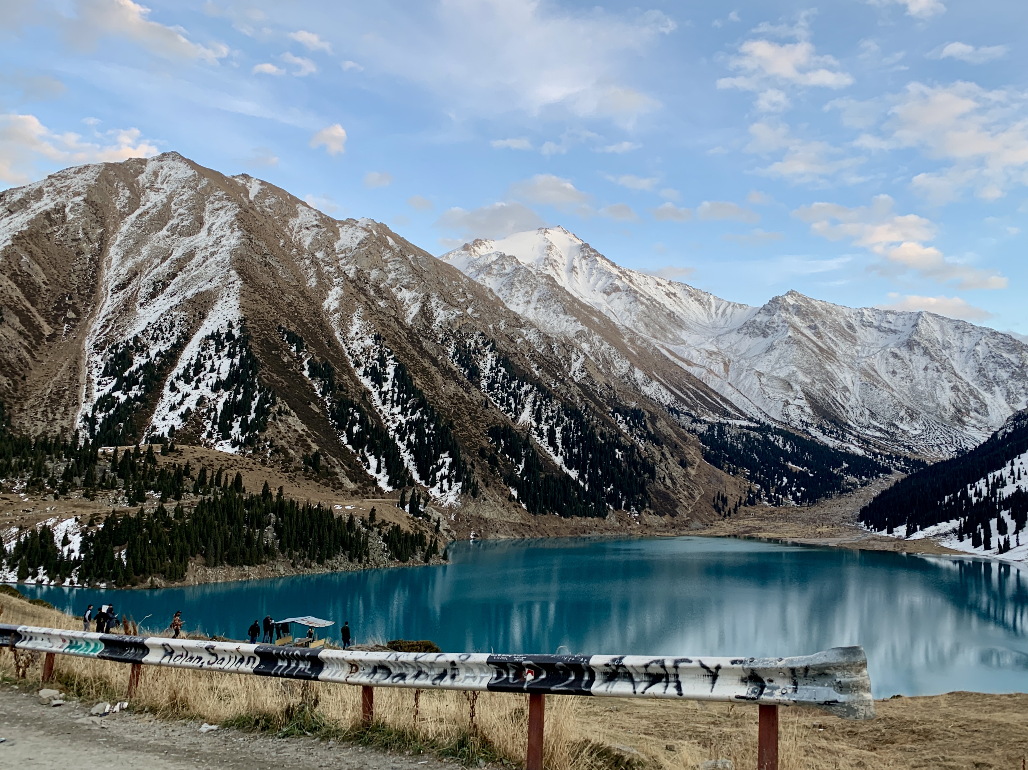 Wide winter panorama of Big Almaty Lake and snow-covered mountains