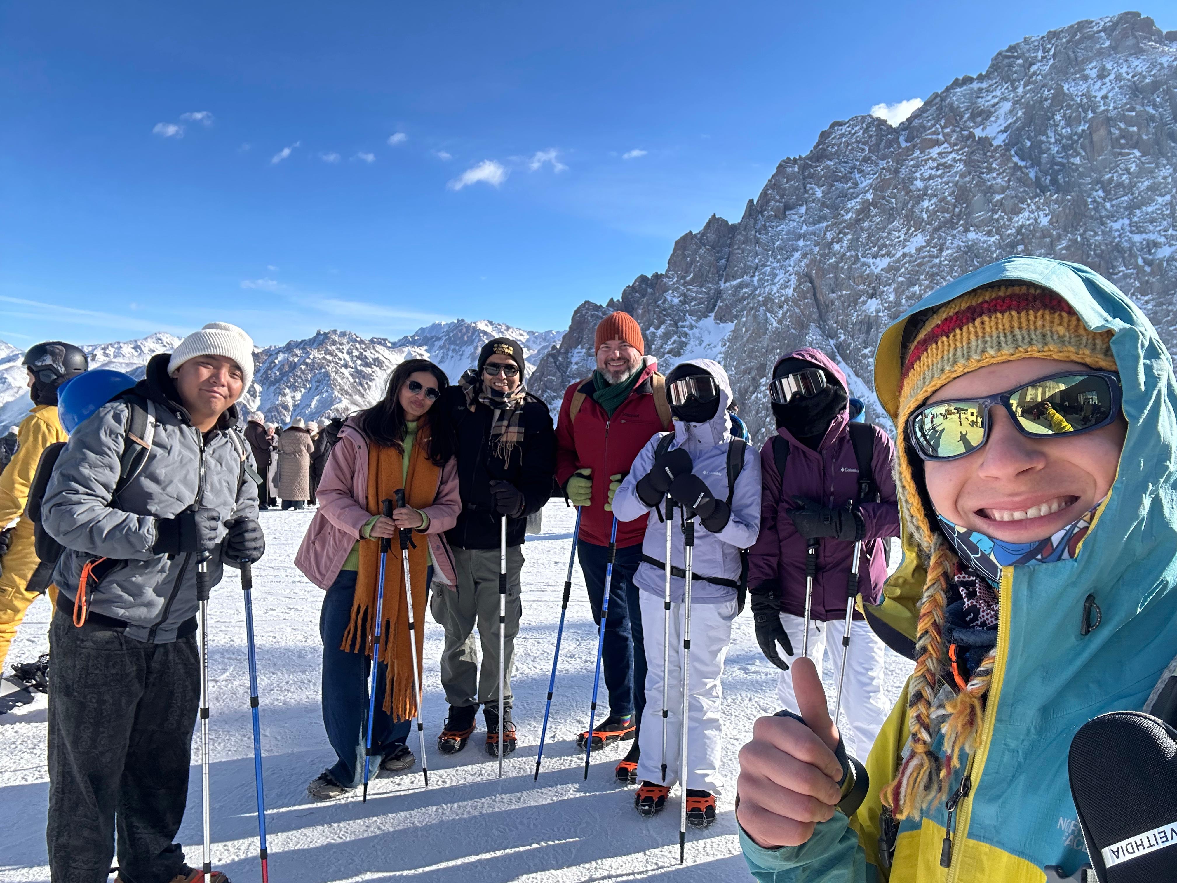 A group of travellers with their guide on a snowy mountain plateau