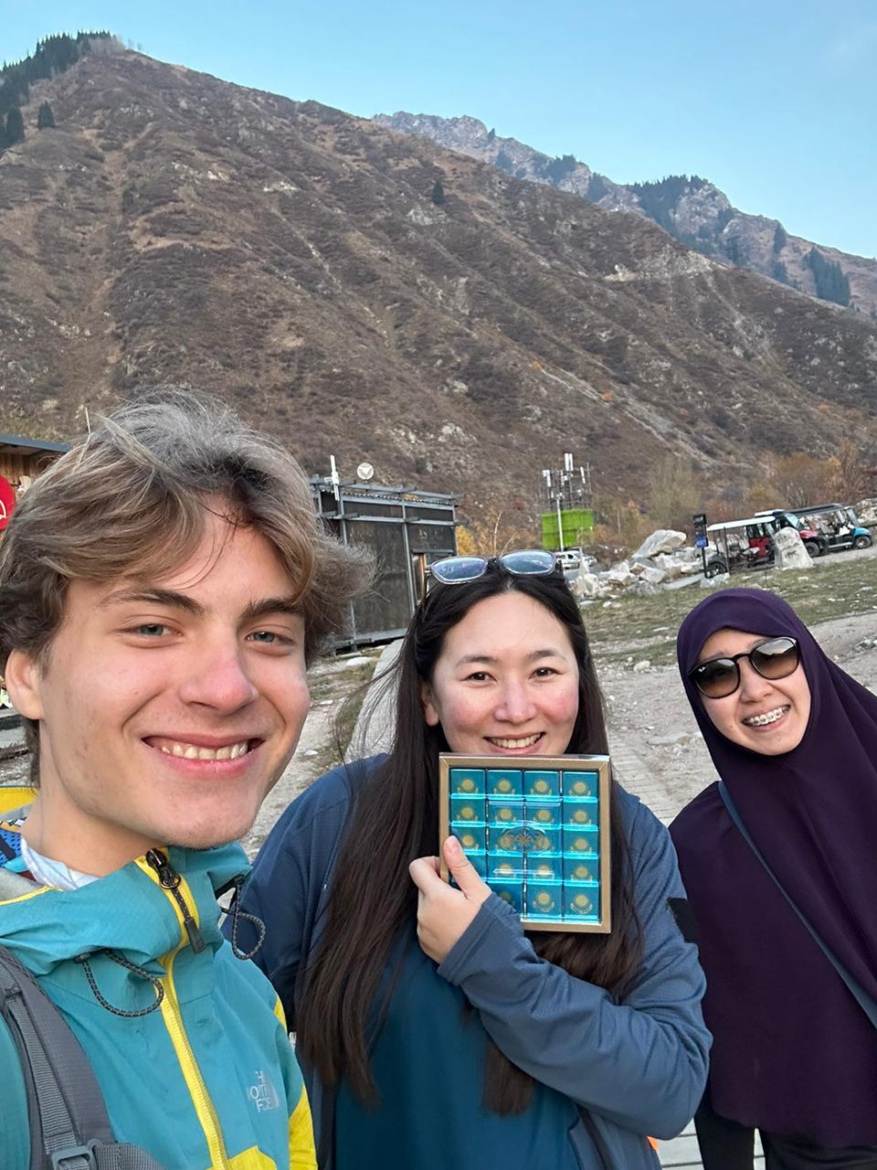 Two guests with their guide after a personal mountain tour
